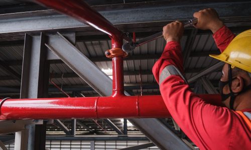 Technician-repairing-a-fire-sprinkler-system